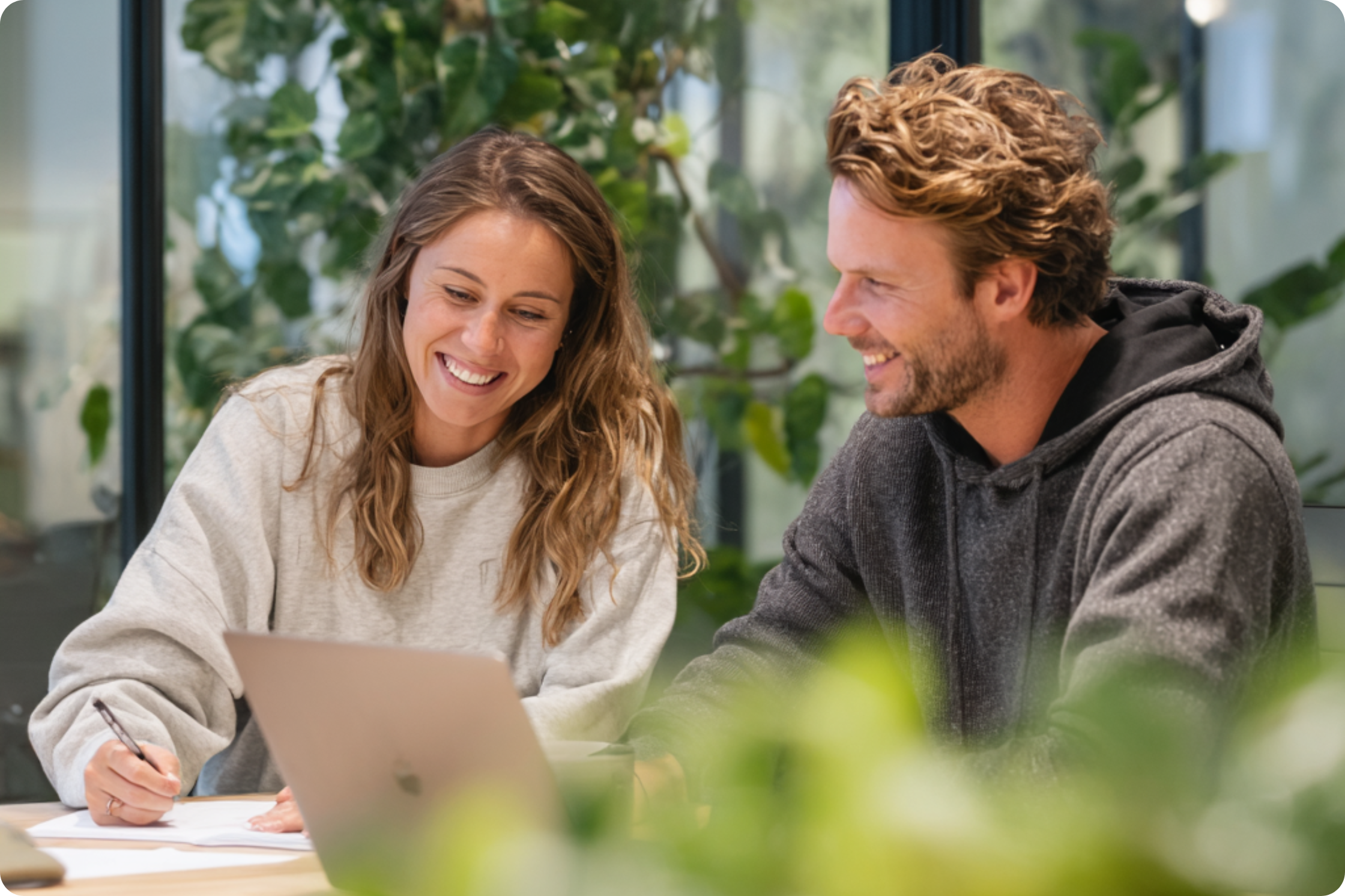 two people sitting talking at desk