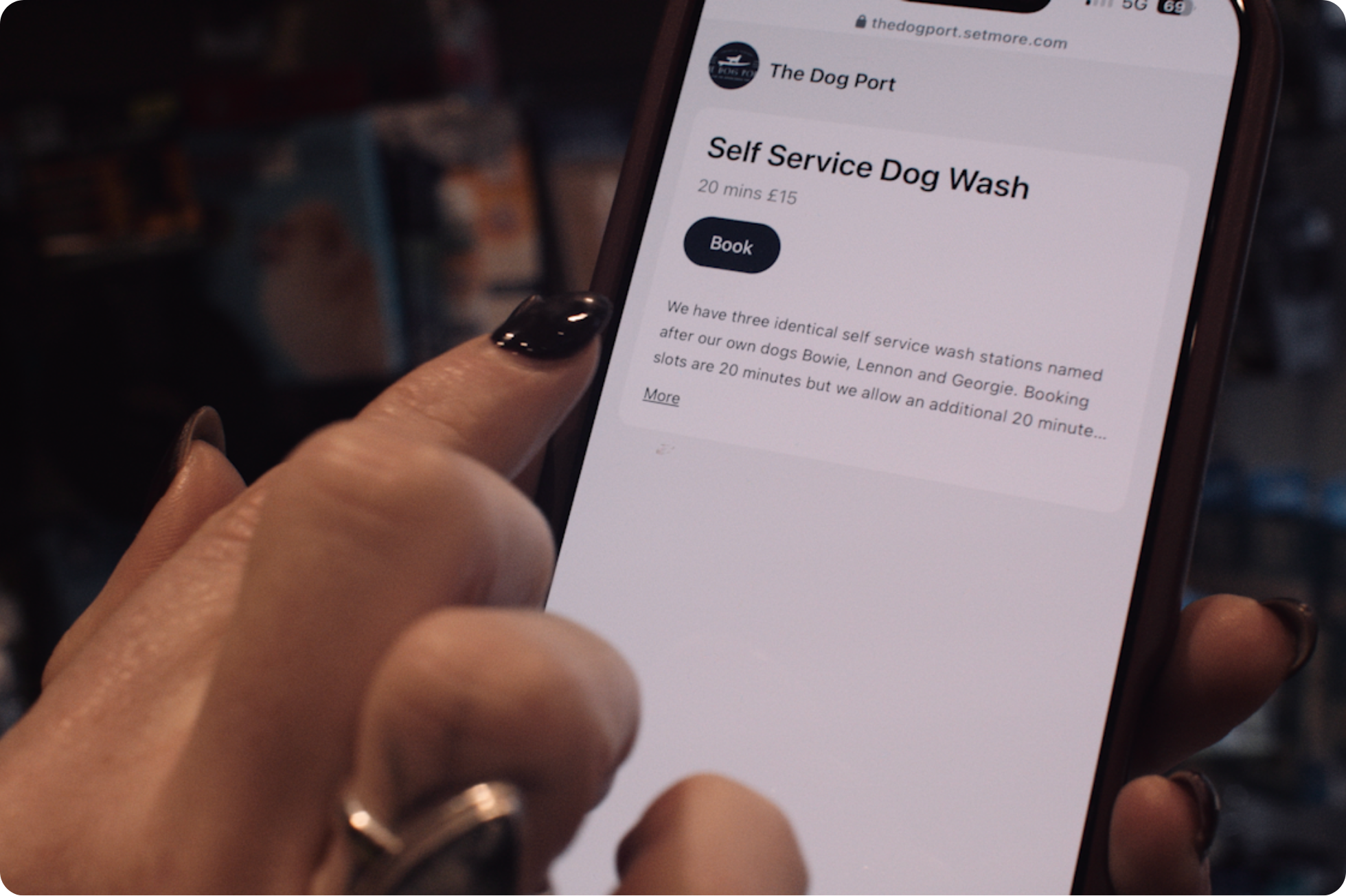 a hand ready to click 'Book' on a service on a Setmore Booking Page