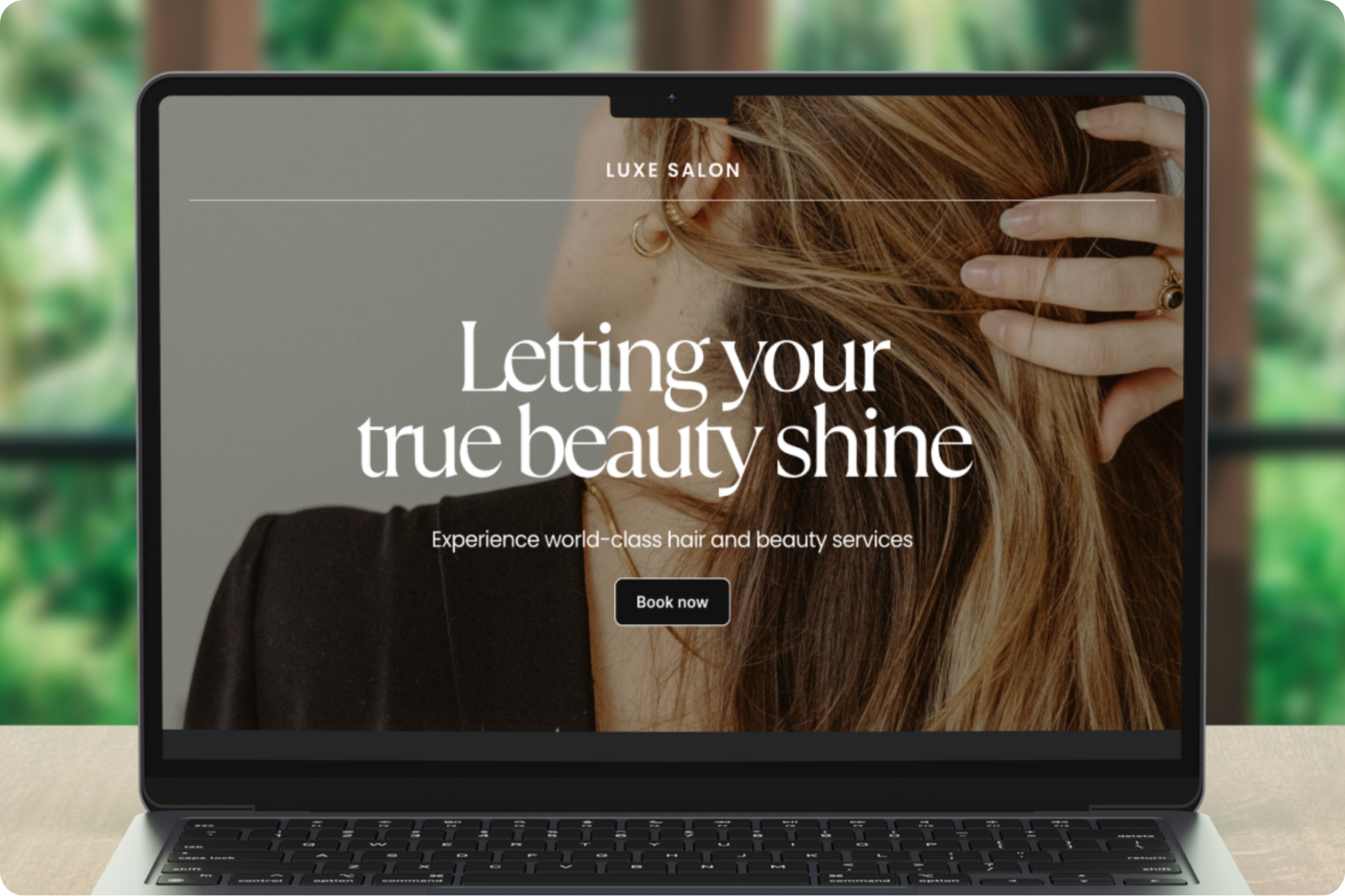 a laptop showing a website for a beauty salon, there is a 'Book now' button on the website