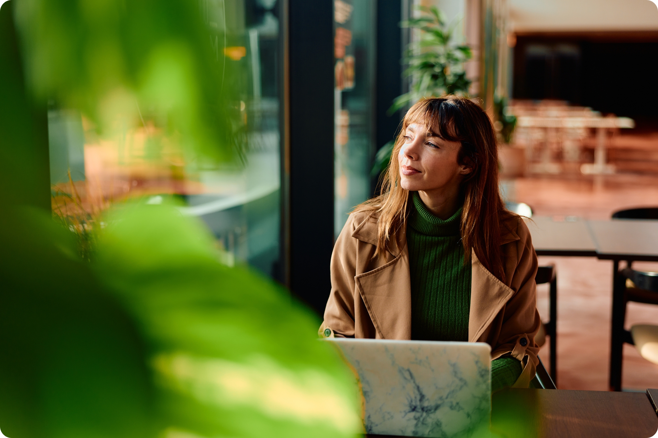 a woman sitting a laptop in cafe 