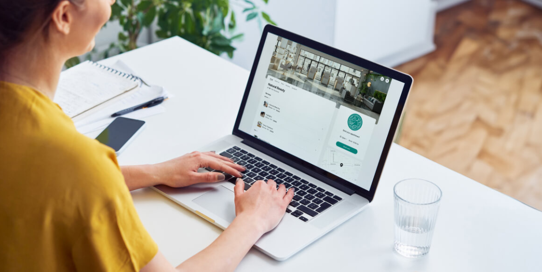 Setmore Booking Page on laptop, woman typing