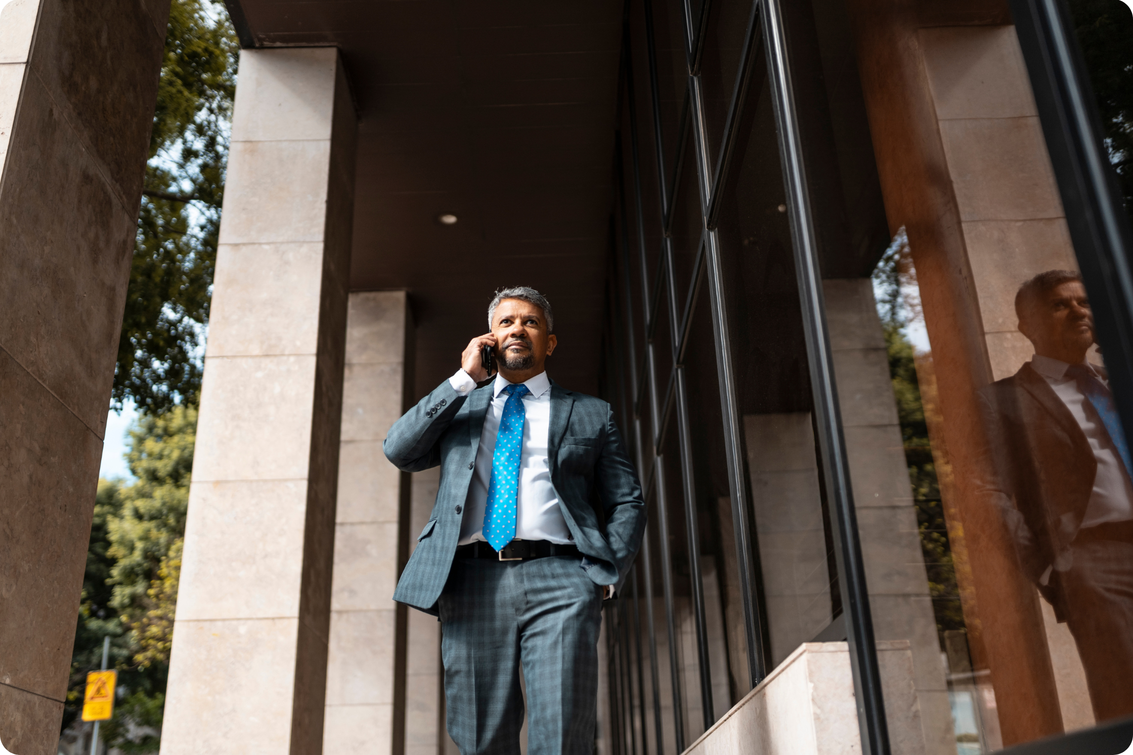 man on his phone, wearing suit, professional