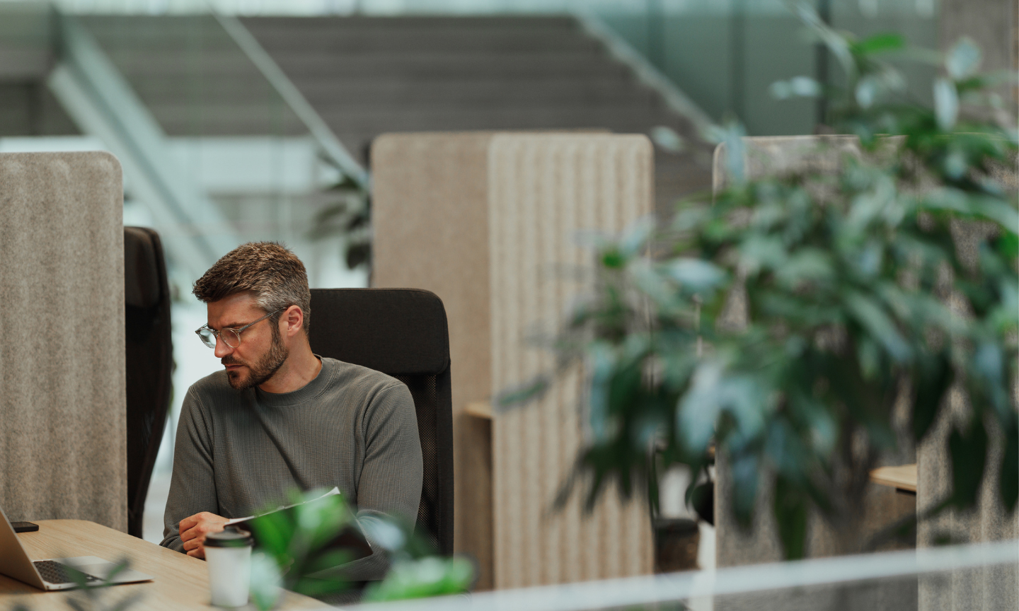 man thinking, sitting at desk