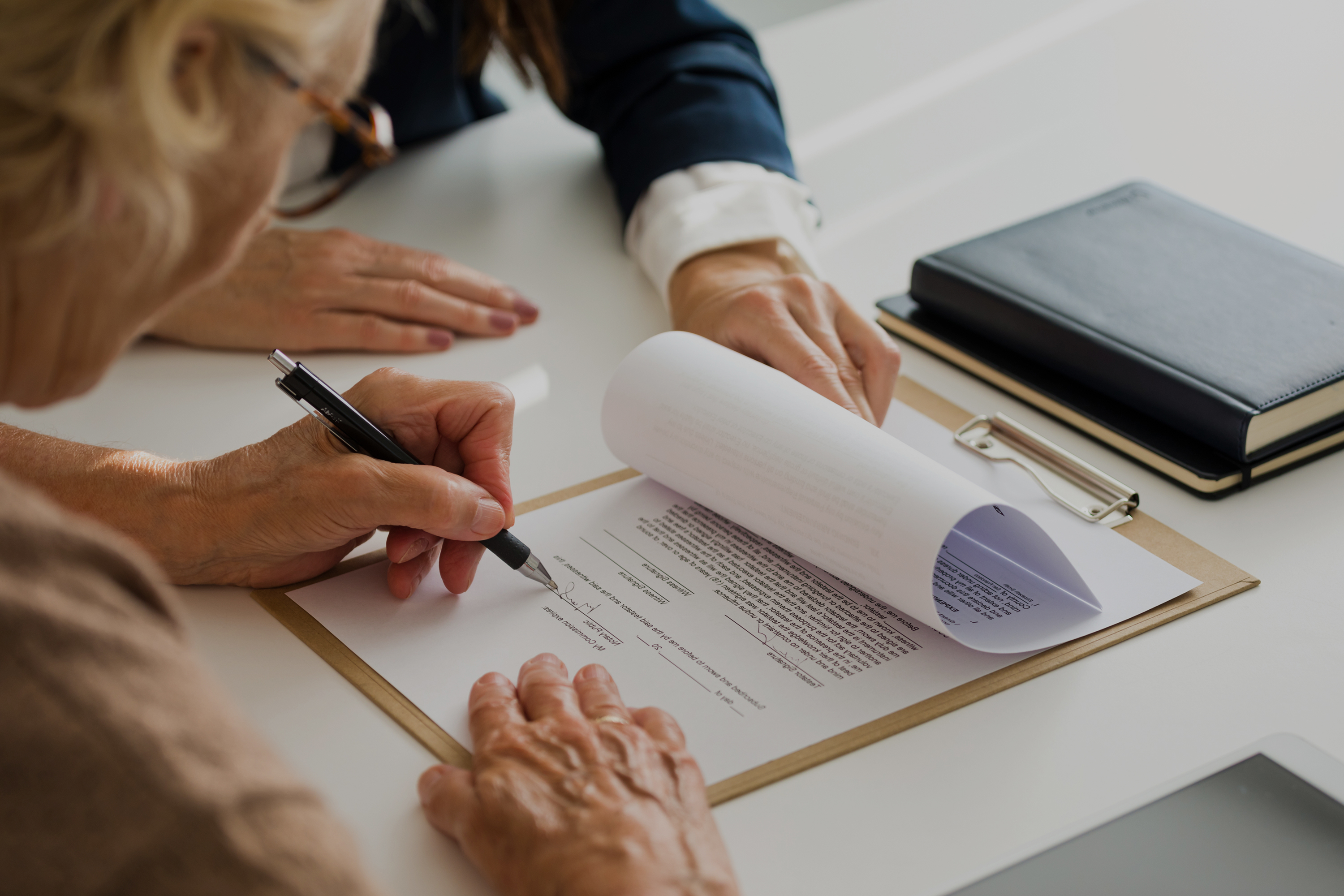 woman signing a document