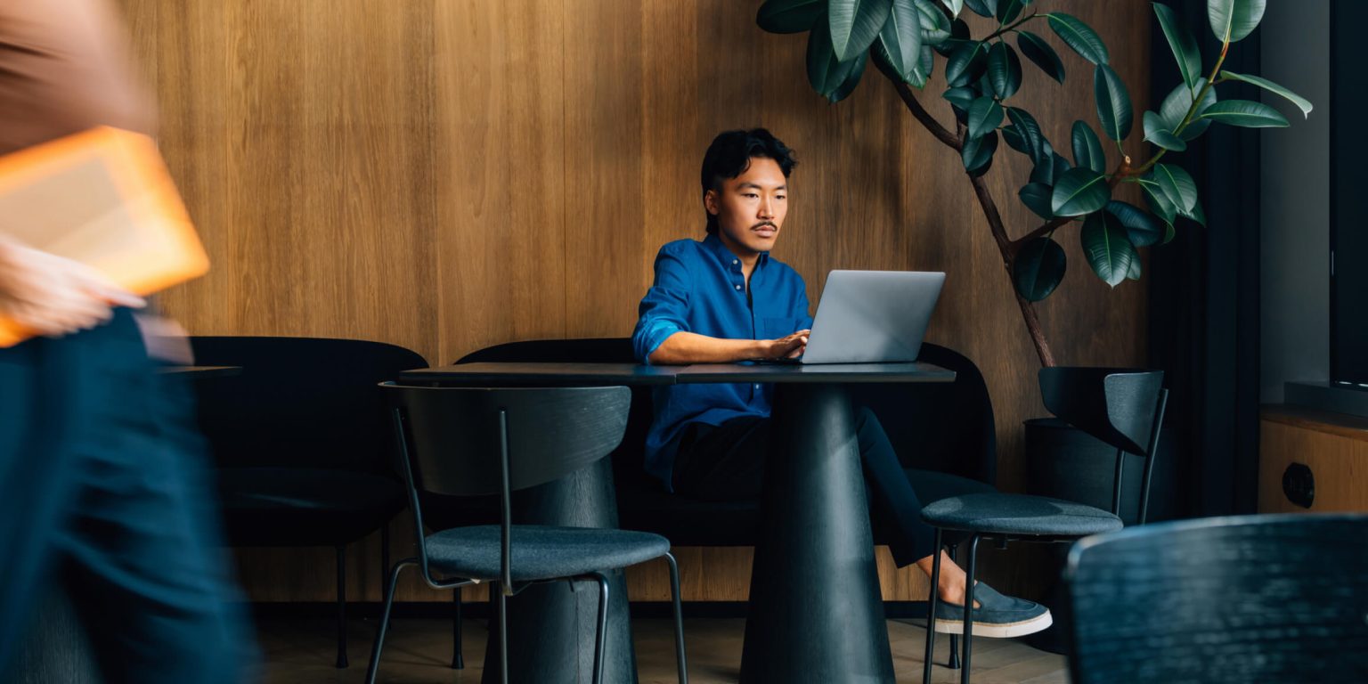 Man looking at laptop on a desk