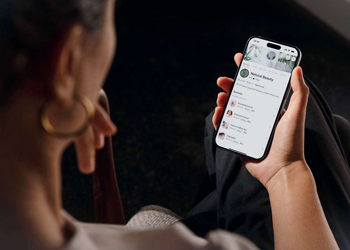 woman looking at a mobile booking page