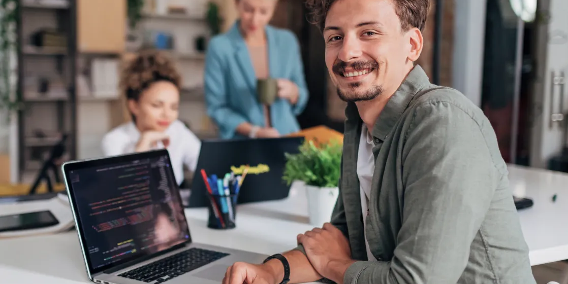 Smiling man working on coding website